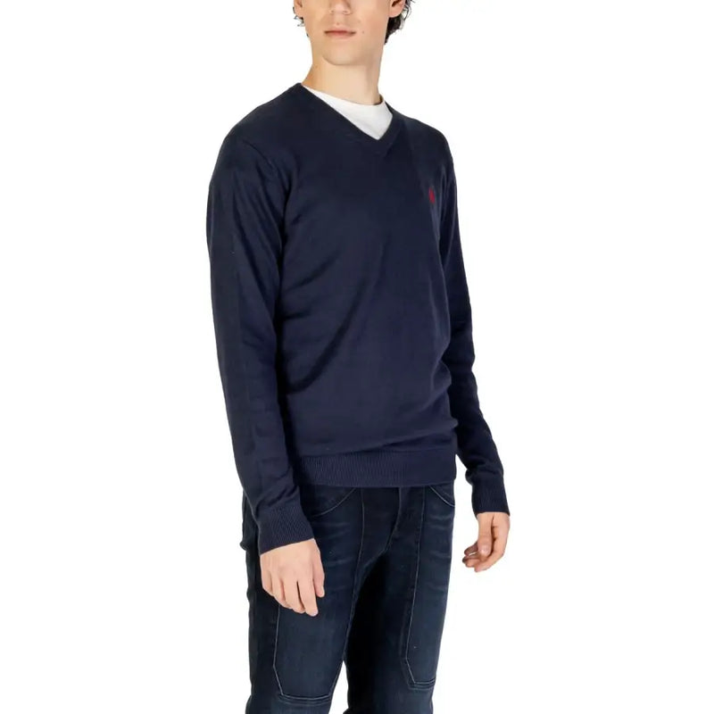 Navy blue knitted v-neck sweater with a small red embroidered logo on the left chest from the knitted clothing collection