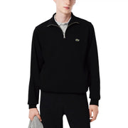 Schwarzer Lacoste Herren-Baumwollpullover mit halbem Reißverschluss und dezentem grünem Krokodillogo auf der Brust