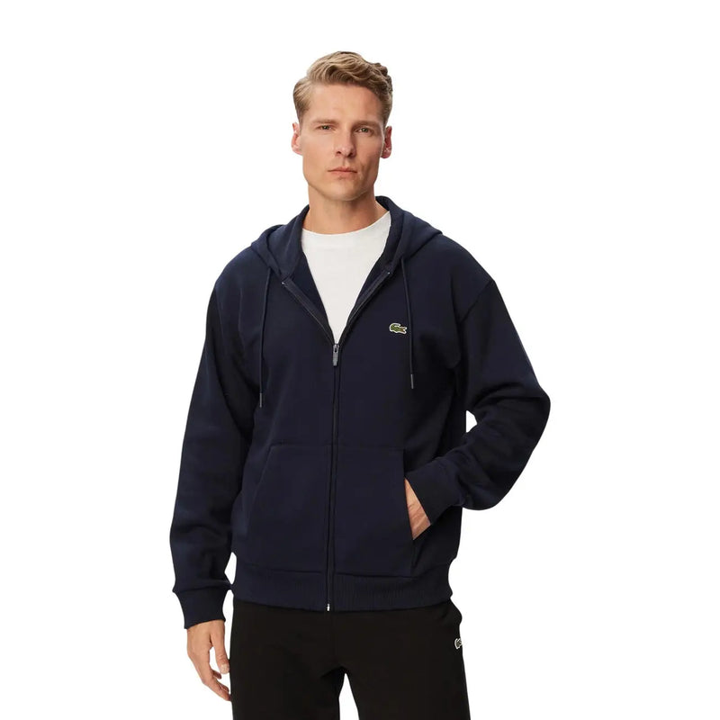 Marineblauer Lacoste Herren-Kapuzenpullover aus Baumwolle mit Reißverschluss und kleinem, gesticktem Krokodillogo auf der linken Brust.