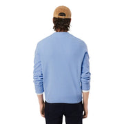 Lacoste men knitwear light blue round neck wool sweater with ribbed cuffs and hem paired with tan corduroy cap