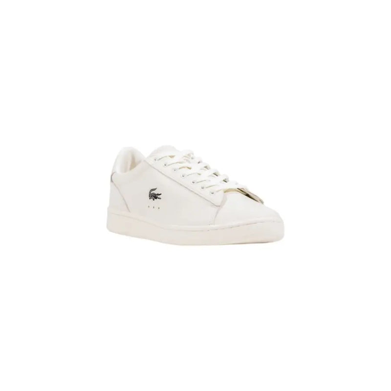White lacoste sneakers with gold accents and crocodile logo.