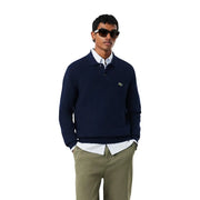 Lacoste Wollpullover für Herren in Marineblau mit grünem Krokodillogo auf der linken Brust, Vorderansicht