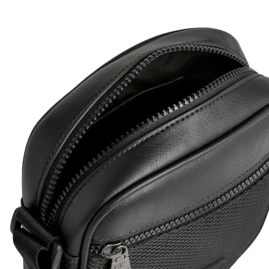 
                      
                        Calvin Klein black leather fanny bag for men showcasing urban city fashion style
                      
                    