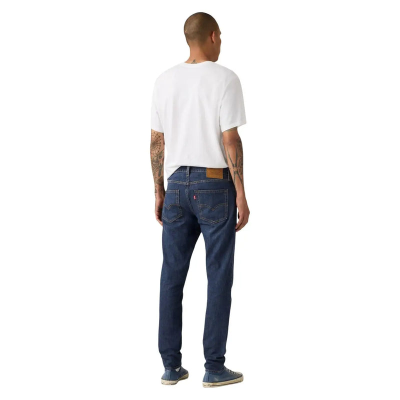 Back side of dark blue Levi’s men blue cotton linen jeans with classic five-pocket design and brown leather patch