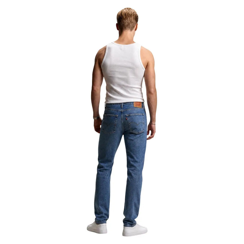 Back side of levi’s men jeans blue classic denim with five-pocket design and brown leather patch on cotton lyocell blend