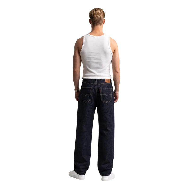 Dark indigo levi’s men jeans with classic five-pocket design and brown leather brand patch on back waistband