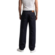 Dark indigo cotton levi’s men jeans with classic brand tab and distinctive back pockets shown from the back side