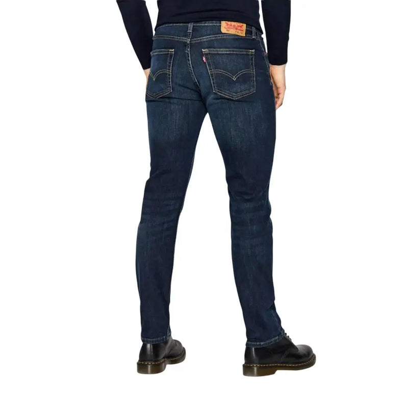 Rückansicht der Levi's Herrenjeans, blauer Baumwoll-Stretch, reguläre Passform, dunkelblauer Denim, fünf Taschen und rotem Lederpatch.