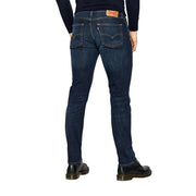 Back view of levi’s men jeans blue cotton stretch regular fit in dark indigo denim with five pockets and red leather patch
