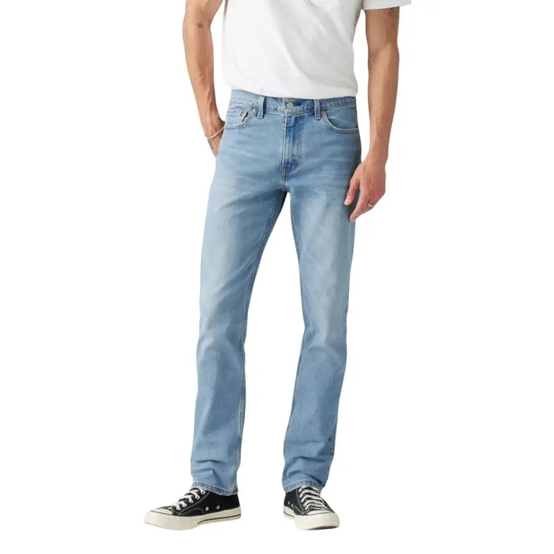 Light blue denim jeans with a straight fit and classic wash design, featuring black converse sneakers.