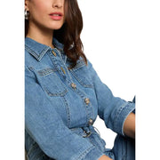 Light blue belted jumpsuit with pockets and three quarter sleeves featuring a blue denim jacket with metallic buttons and collar