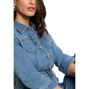 Light blue belted jumpsuit with pockets and three quarter sleeves featuring a blue denim jacket with metallic buttons and collar