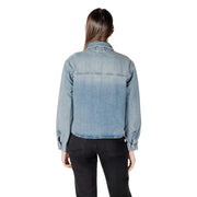 Women wearing a light blue ombre denim shirt with black pants in a classic round neck blouse