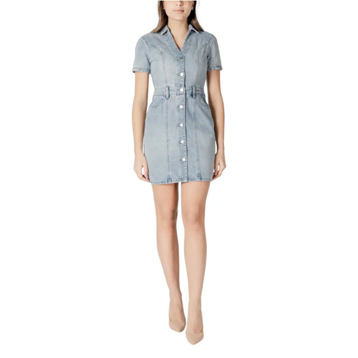 Light blue cotton button front dress with v neck, short sleeves, fitted waistband, and pockets in light-wash denim