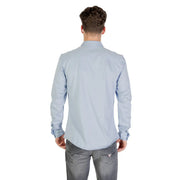 Light blue long sleeved dress shirt with classic collar and buttoned cuffs made of soft breathable fabric