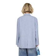 Light blue women’s oversized blazer with button front, structured shoulders, pockets, and a minimalist design