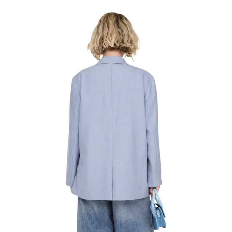 Light blue women’s oversized blazer with button front, structured shoulders, pockets, and a minimalist design