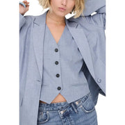 Light blue women’s blazer with textured fabric black buttons and a structured collar with front pockets