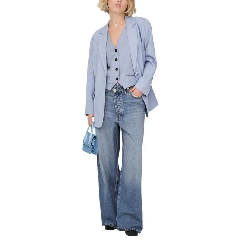 Light blue denim flared pants complementing a women’s blazer with button front and pockets in light blue fabric
