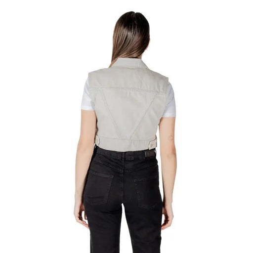 A light gray denim vest with a collar and buttoned waistband made from durable denim material