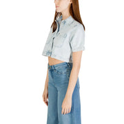 Light wash denim cropped shirt with short sleeves paired with wide-leg jeans for women