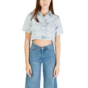 Light wash denim crop top with chest pockets paired with wide-leg jeans for women