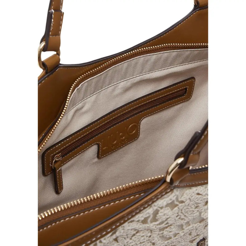Liu Jo beige cotton handbag featuring brown leather with lace trim and gold-tone hardware with zip pocket