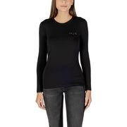 Black long-sleeve round neck T shirt with rhinestones paired with dark grey jeans