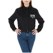 Women’s black long-sleeved button-up blazer with white text, featuring zip and pockets
