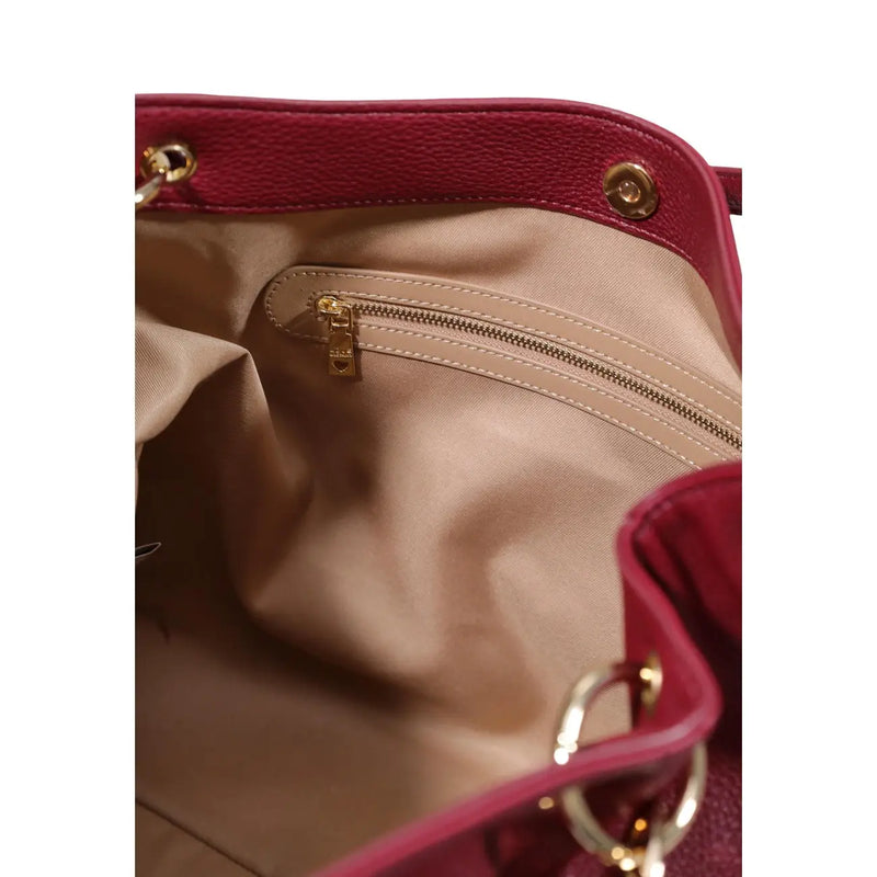 The interior of a love moschino women purple bag features burgundy textured leather, gold-tone hardware, and beige lining