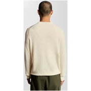Cream cashmere sweater with ribbed cuffs and hem, classic crew neck design.