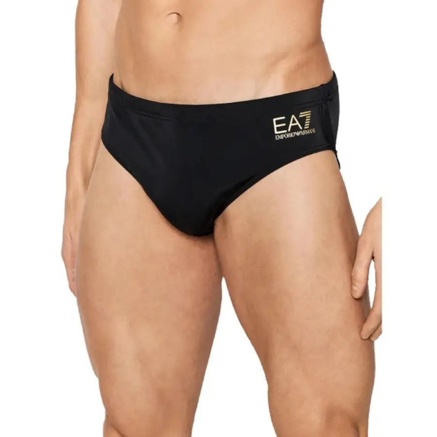 Ea7 EA7 men swimwear featuring a man in a black bikini with a gold logo