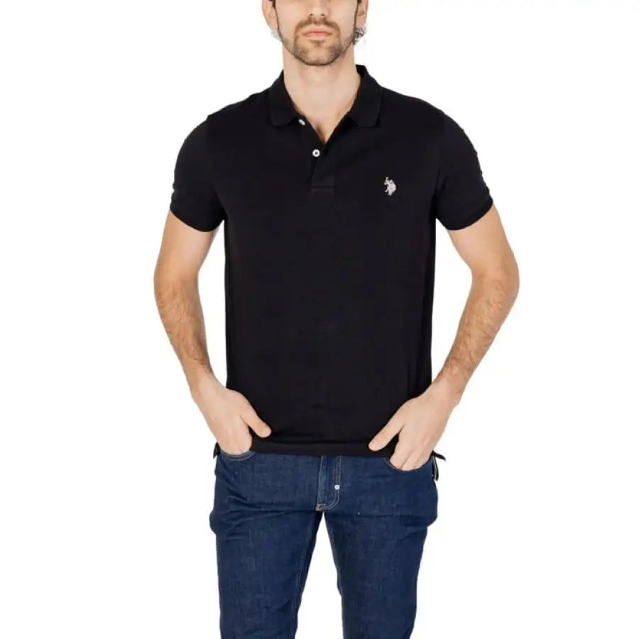 
                      
                        Man wearing U.S. Polo Assn. black men polo and jeans in apparel accessories.
                      
                    