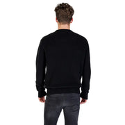 Male model wearing Black Ribbed Knit Sweater and Gray Jeans in a casual setting