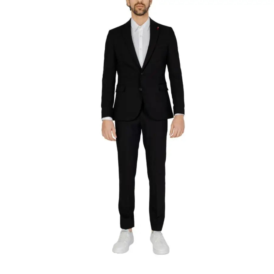 Man in black suit and white shoes showcasing urban city style from Mulish Men Suit collection