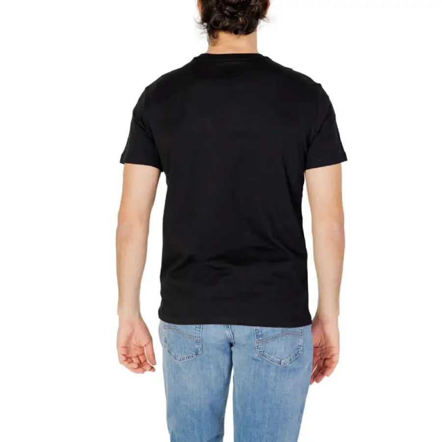 Man modeling Armani Exchange men T-Shirt in black with jeans