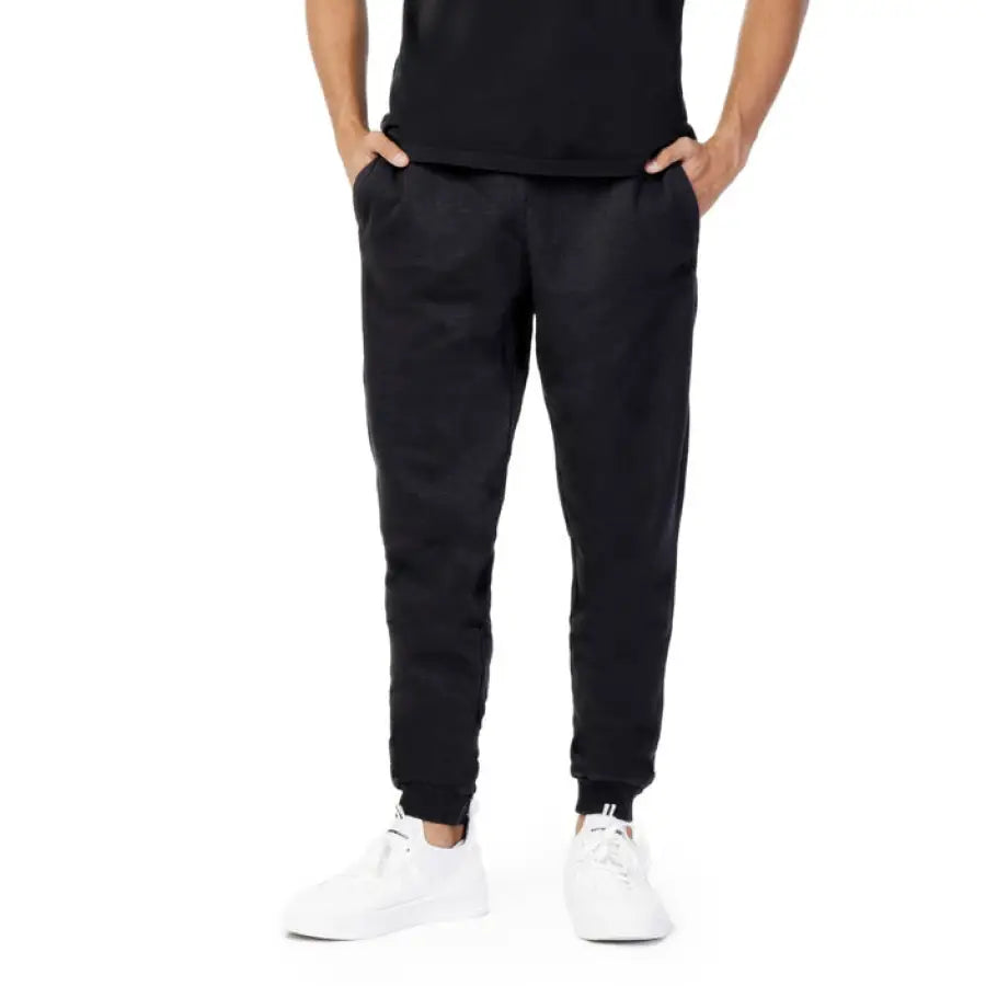 Fila Men in black Fila T-shirt and Fila men trousers posing