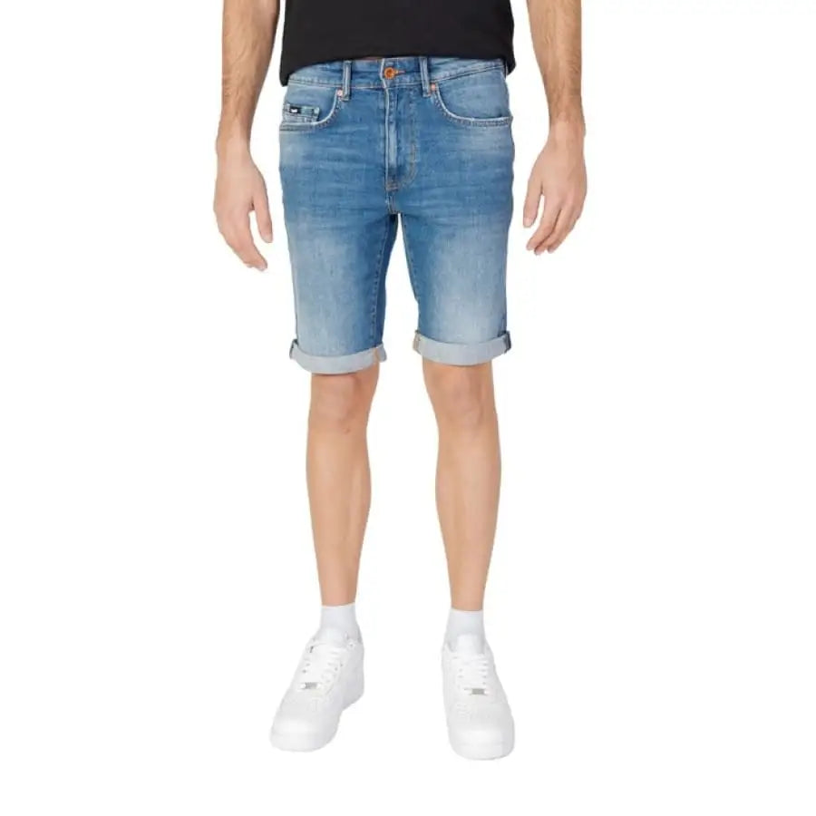 Gas Gas Men Shorts for spring summer: Man in black t-shirt and blue denim shorts.