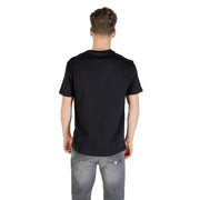 Man wearing Black AX Logo T Shirt and gray jeans for stylish casual wear