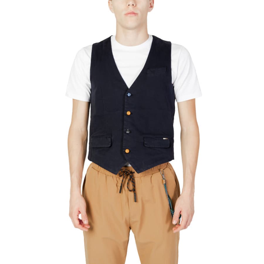 Gianni Lupo men in stylish urban style clothing, black vest and tan pants