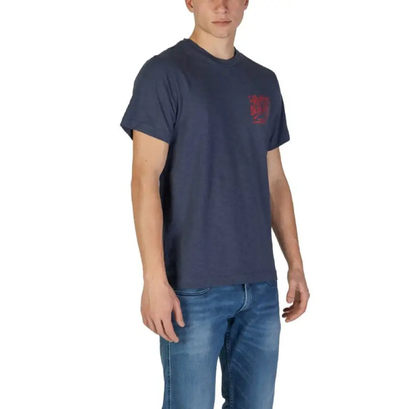 Man wearing a navy blue t shirt with red lettering and jeans for the product display