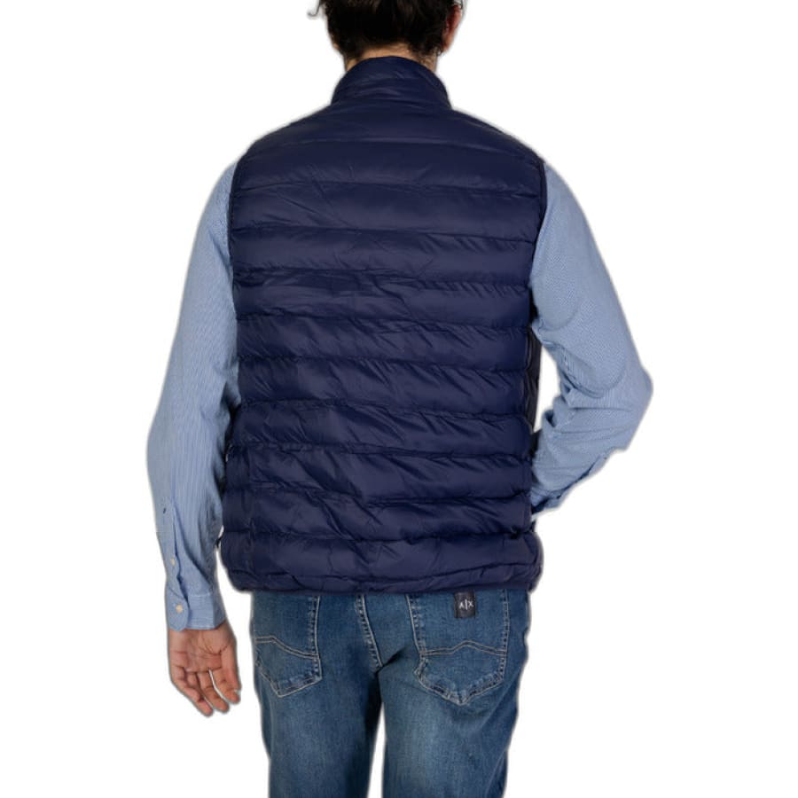Man in blue Polo Assn gilet and jeans showcasing urban style clothing