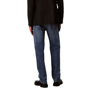 Man in dark blazer and blue jeans standing confidently for the Man in Black Blazer and Blue Jeans product