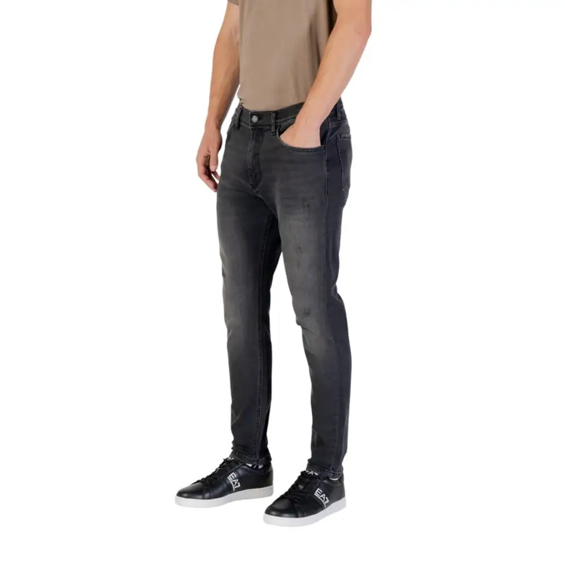 Man wearing gray slim fit jeans and black sneakers from Gray Slim Fit Jeans collection