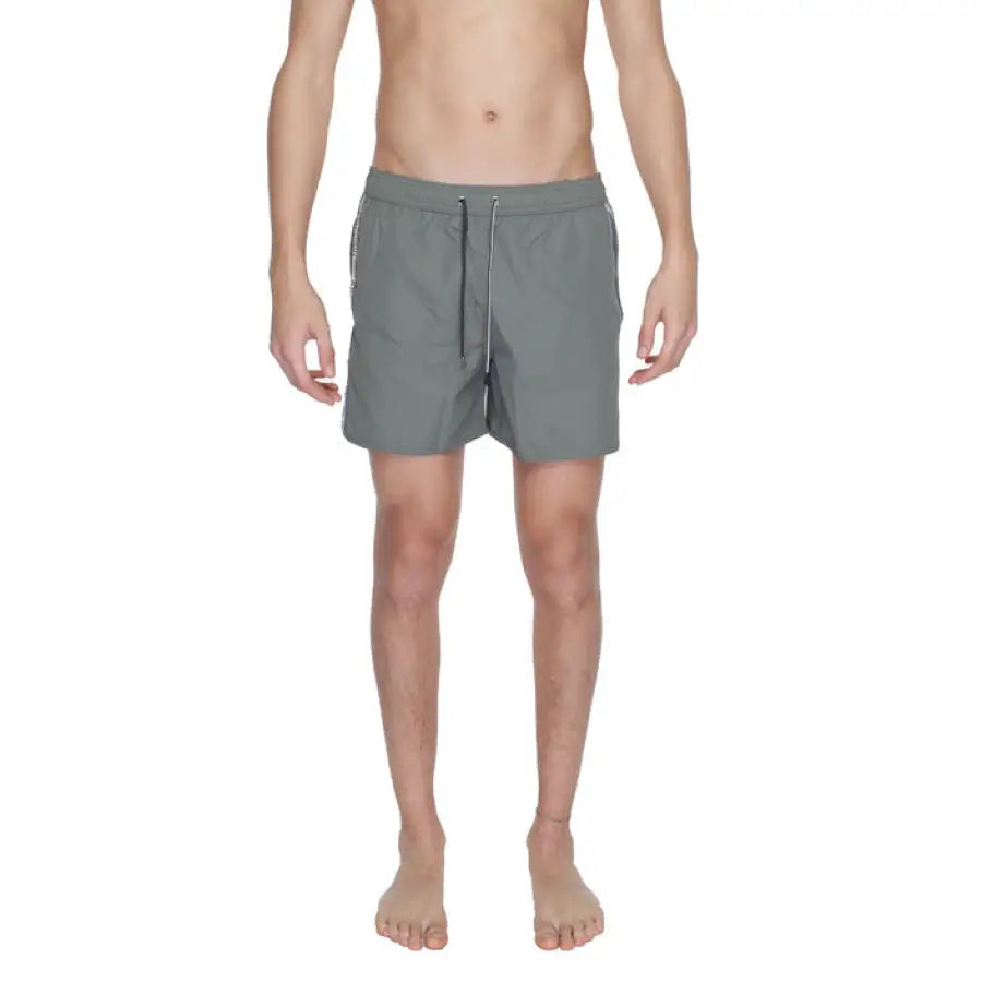 
                      
                        Emporio Armani swimwear for men, model in gray swimsuit
                      
                    