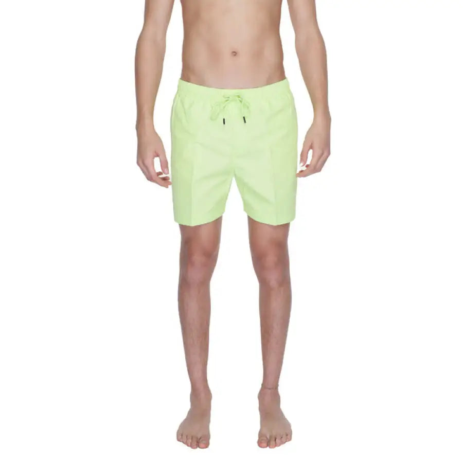 
                      
                        Man wearing Calvin Klein Men Swimwear in green
                      
                    