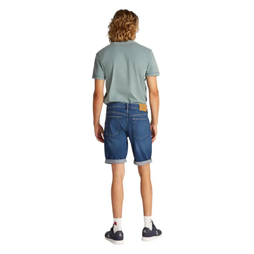 Man wearing a green T-shirt and blue denim shorts for Mens Green T-Shirt and Blue Denim Shorts product
