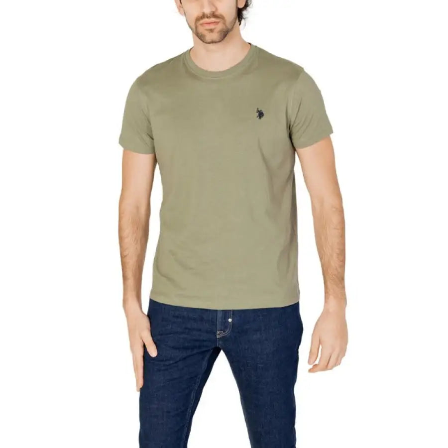 Man modeling U.S. Polo Assn. men t-shirt in urban style clothing, green tee and jeans