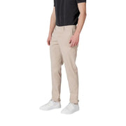 Man wearing Replay Men Beige Trousers with Zip and Button Closure and white sneakers