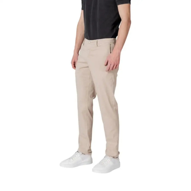 Man wearing Replay Men Beige Trousers with Zip and Button Closure and white sneakers